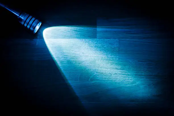 Photo of Flashlight shining a beam of light in darkness