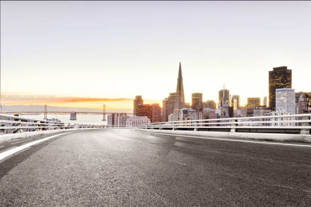 istock empty road with modern city at sunrise 686929224