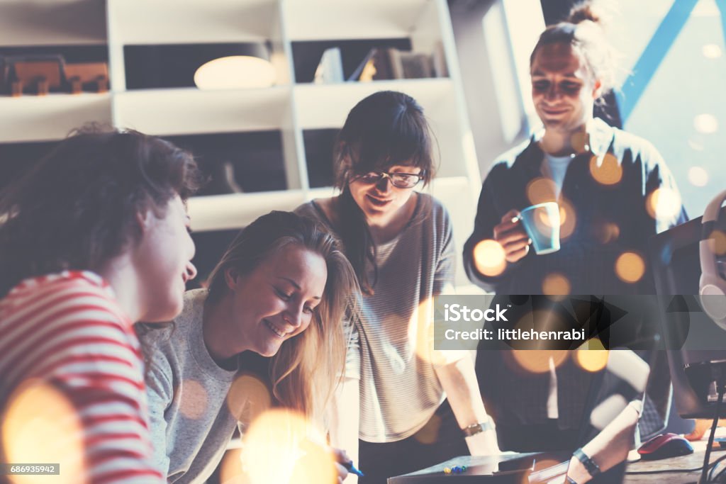 Young business team working together Group of business people working together in big loft office. Marketing department discussing new product plan. Intentional lens flares Creativity Stock Photo