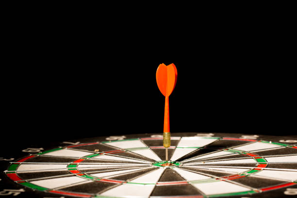 istock red darts hitting the center of target on black background 686941870
