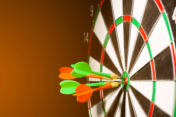 istock red darts hitting the center of target on black background 686945834