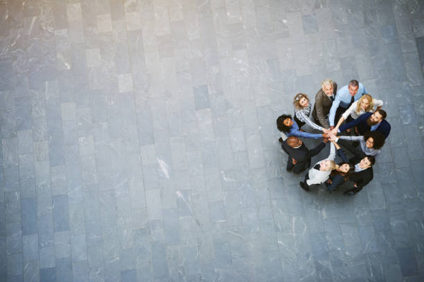 istock Multiethnic office team with hands stacked looking up in hall 686945886