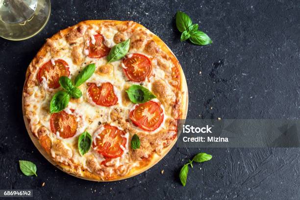 Pizza Margherita Stock Photo - Download Image Now - Pizza, Backgrounds, Dark