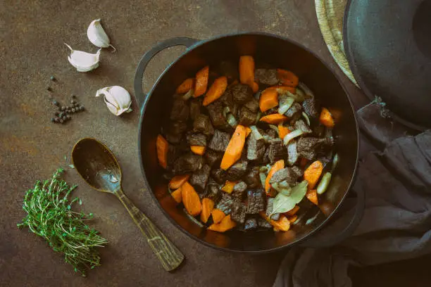 Beef stew in a cast iron pan, view from above