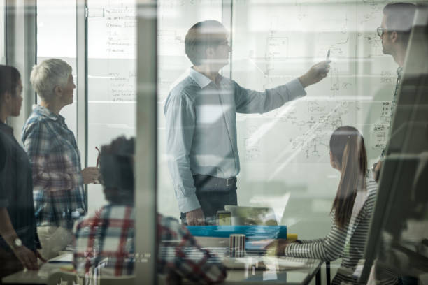istock CEO explaining his team their new business plan in the office. 686947808