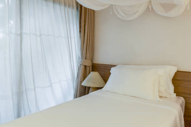 istock two pillow on bedroom with white bed sheet and lamp 686952640