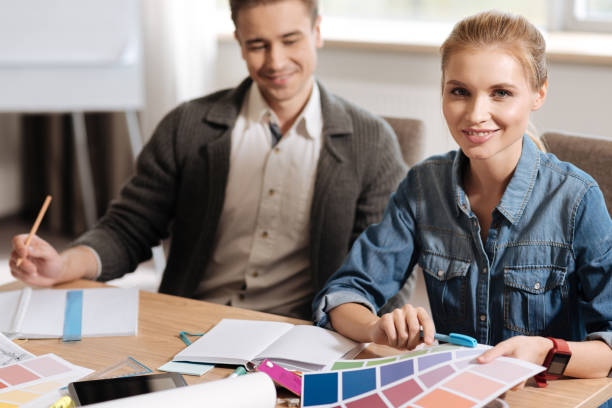 istock Pleasant beautiful woman working with her colleague 686960926
