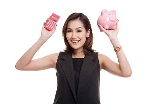 Asian woman with calculator and piggy bank isolated on white background