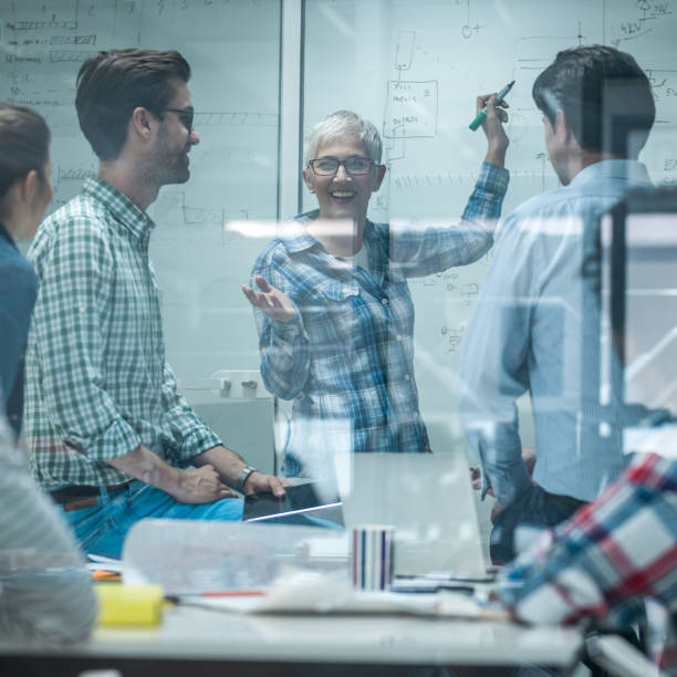 istock Happy female entrepreneur communicating with her team on a meeting. 686961374
