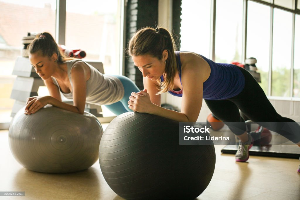 Young woman workout in healthy club. Young woman on Pilates ball. Fitness Ball Stock Photo