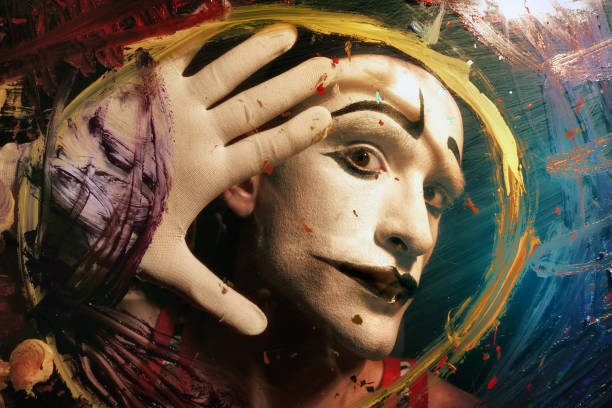 Face of Mime behind glass with multi-colored paint stains