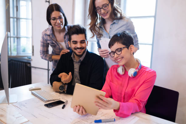istock Creative young business people and architects working in office 686967562