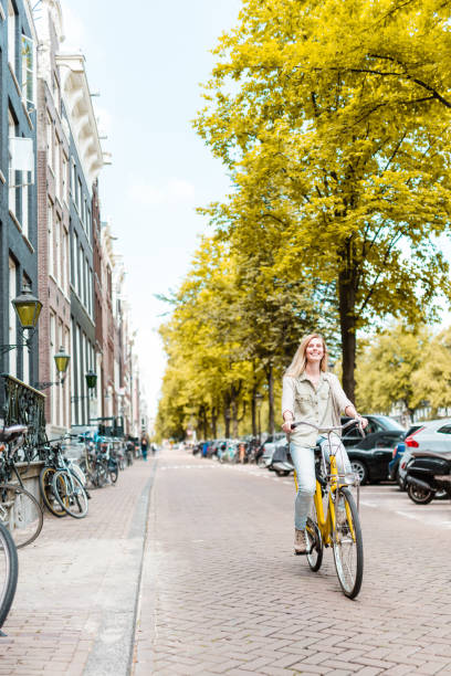 istock blonde woman walking in amsterdam 686969734