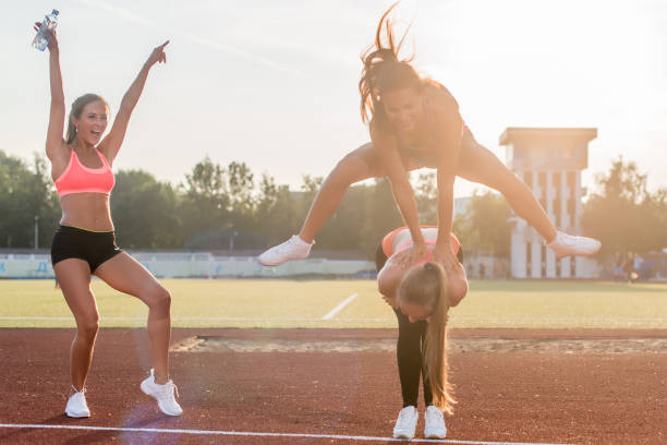 istock Fit women in the stadium playing leap frog. 686974964