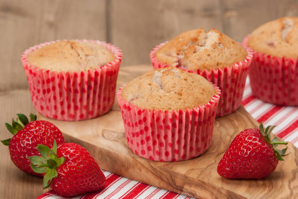 istock Homebaked Strawberry Cupcakes In Paper Cases. Strawberries. Olive Tree Board. 686982652