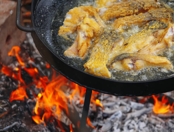 istock Frying pieces of fish on a barbecue pan. 686983076