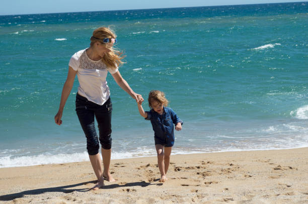 istock Mother and son having fun on the beach 686989136
