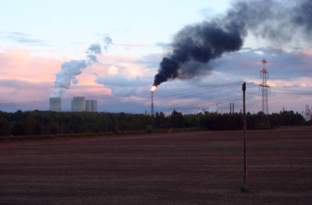 Soot and steam clouds over an industrial area in Saxony at dusk