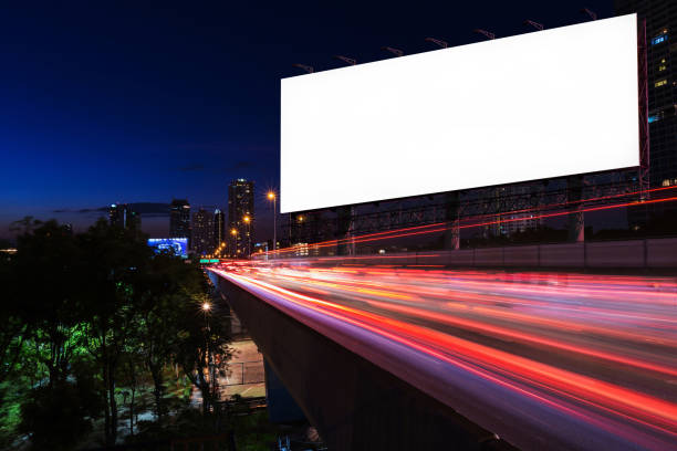 istock White blank billboard near light trails street the in night 686996316