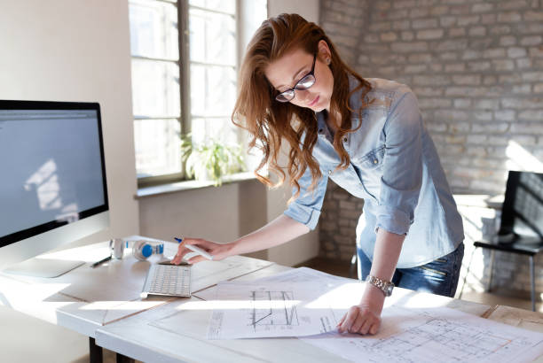 istock Female designer in office working on architects project 686996906