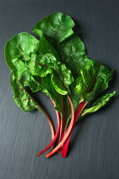 istock Top view of fresh beet leaves on the dark background 687000550