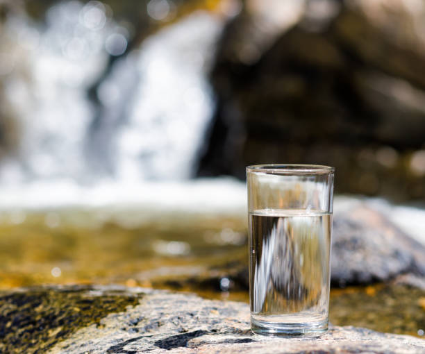 istock Glass of water by waterfall 687006388