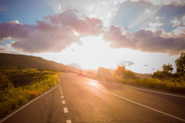 istock panoramic view of empty asphalt road under sunset sky, dusk light sunbeam 687010554