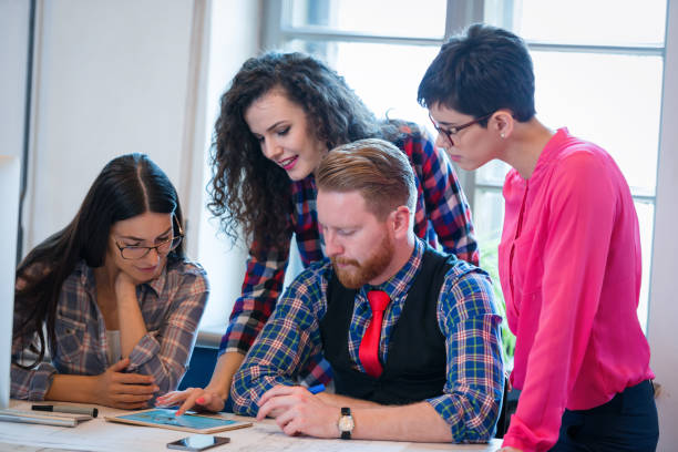 istock Coworkers working on project together in office 687010800