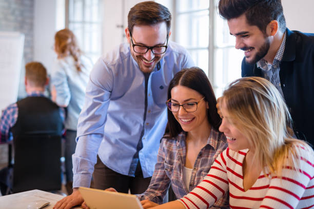 istock Coworkers working on project together in office 687011090
