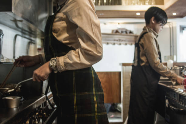 istock Two young woman cooking at a kitchen of restaurant 687011178