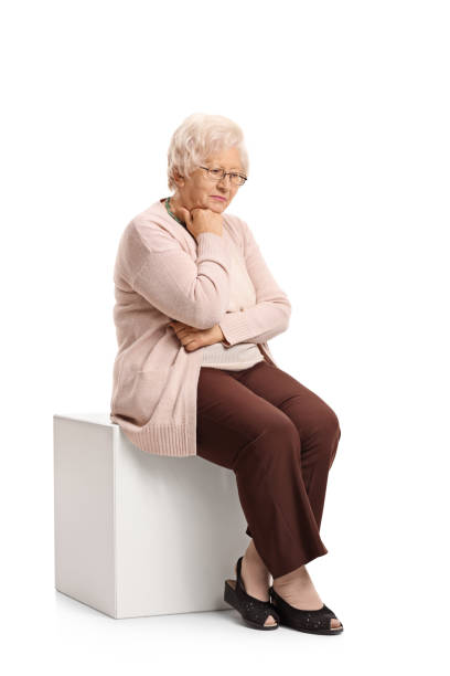 istock Sad mature woman sitting on a cube 687013648
