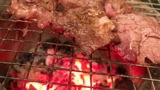 istock beef steak cooking over flaming grill 687018396