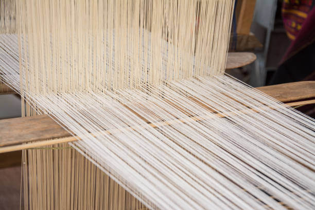 Woman weaving silk in traditional way at manual loom. Thailand Woman weaving silk in traditional way at manual loom. Thailand loom stock pictures, royalty-free photos & images