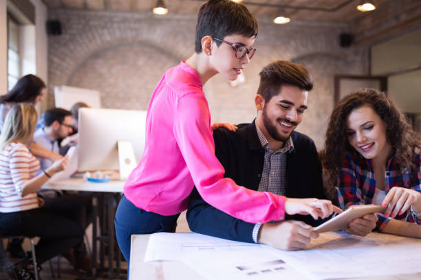 istock Creative young business people and architects working in office 687028566