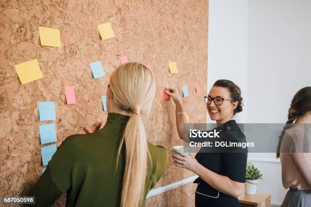 Women Making Business Notes Stock Photo - Download Image Now - Human Resources, Bulletin Board, Working