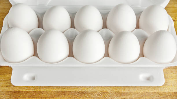 istock Packing eggs in a cardboard box top and close-up view 687053372