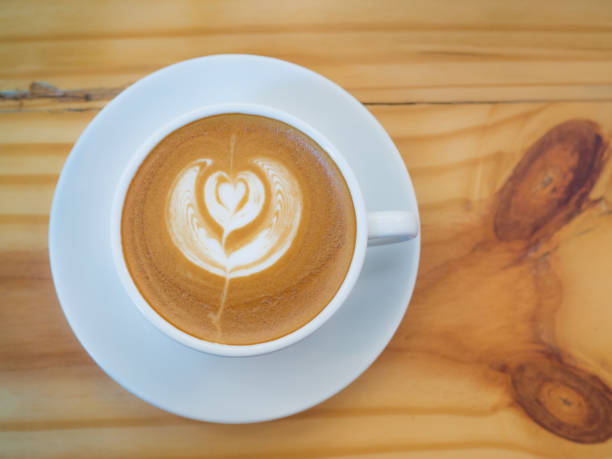 istock A cup of hot coffee on wooden table. 687059900