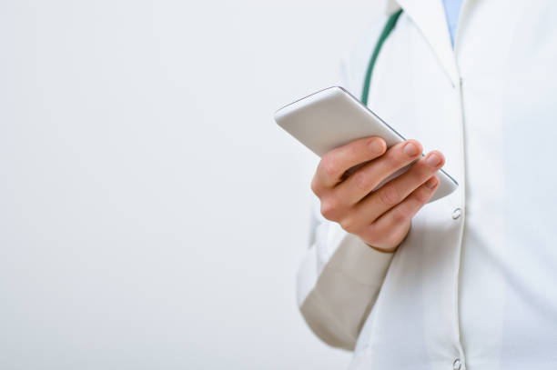 istock A female doctor texting on smartphone 687064876