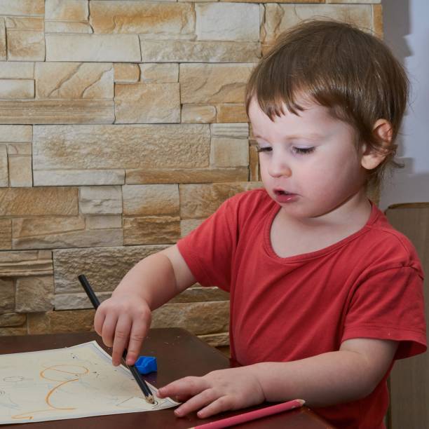 istock little girl drawing on paper 687067386