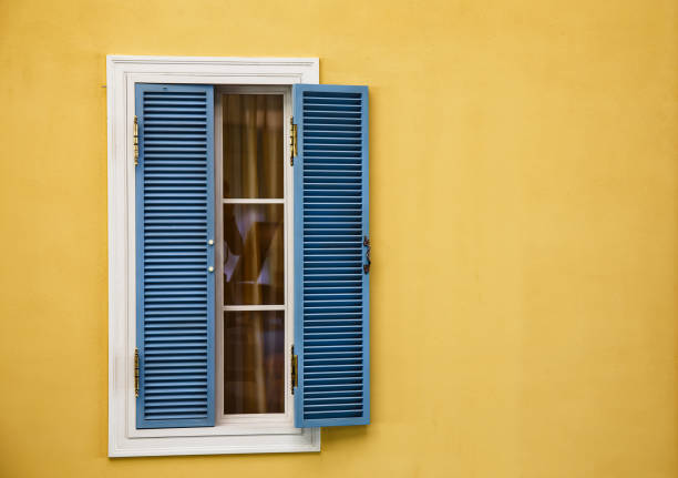istock Wooden windows on yellow walls. 687085340