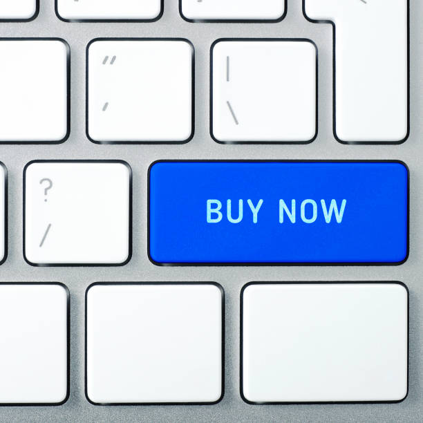 istock Laptop keyboard and blue key with text BUY NOW on it. Square format. 687085704