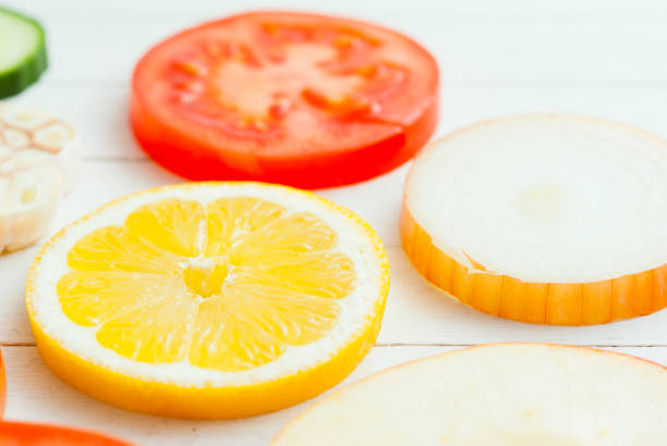 fruit circles - isolated on red still life tomato lemon imagens e fotografias de stock