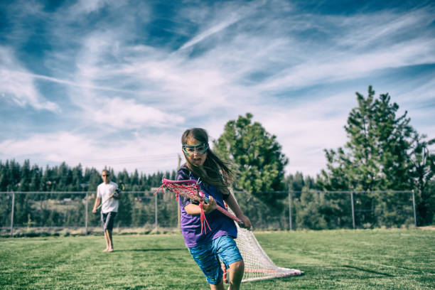istock Fierce little girl playing lacrosse 687097074