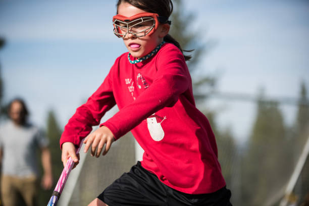 istock Aggressive little girl playing lacrosse 687097082