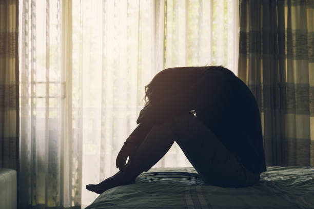 istock Woman Suffering From Depression Sitting On Bed 687101192