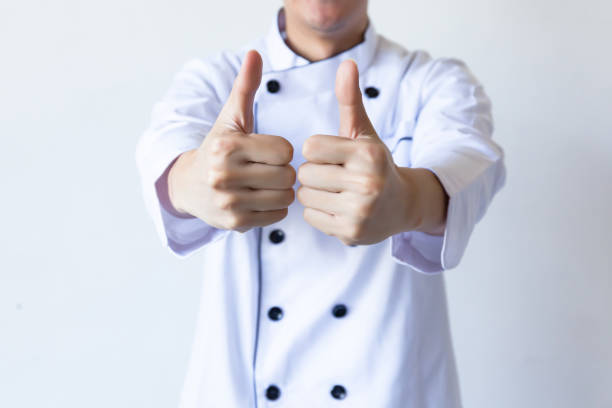 Smiling chef showing thumbs up with white copy space (focus on hands) Smiling chef showing thumbs up with white copy space (focus on hands) chief of staff stock pictures, royalty-free photos & images