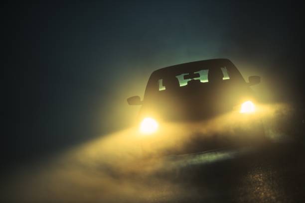 Car Driving in the Fog Car Driving in Dense Fog. Dangerous Road Conditions. Night Time Driving in Fog. dark road stock pictures, royalty-free photos & images
