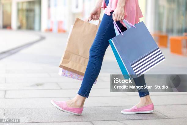 Young Caucasian Woman Walking With Shopping Bags Stock Photo - Download Image Now - Shopping Bag, Sidewalk, Sale