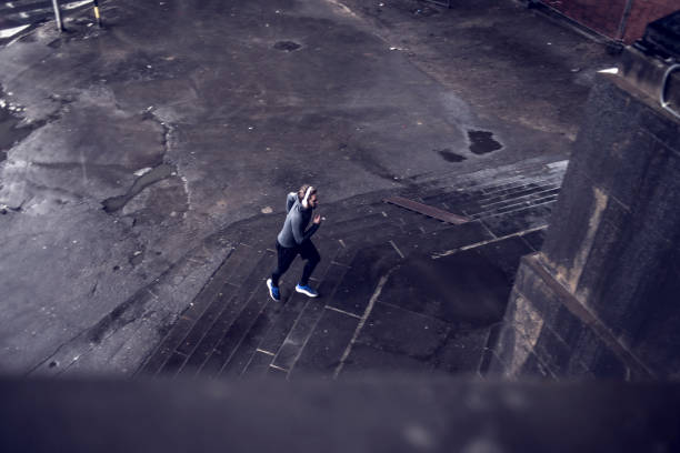 istock man jogging outdoors on a bad weather 687121196