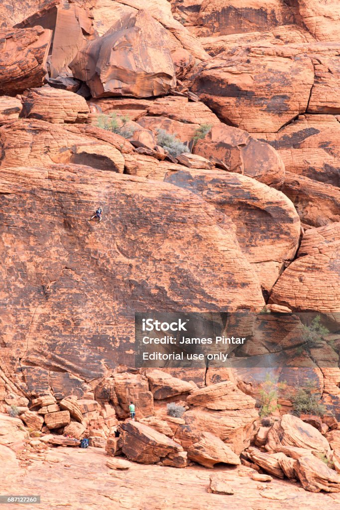 Mountain Climbers Scaling a Red Rock Wall in the Desert Red Rock Canyon, NV - October 27, 2016:  Climbers scaling a rock face at Red Rock Canyon National Conservation Area.  The national park is a popular tourist destination near Las Vegas, Nevada. Athlete Stock Photo